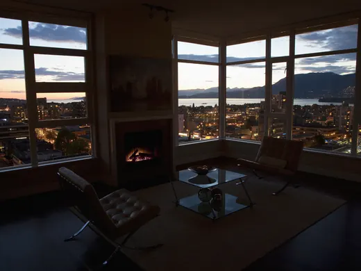 Condo living room with a city view at sunset